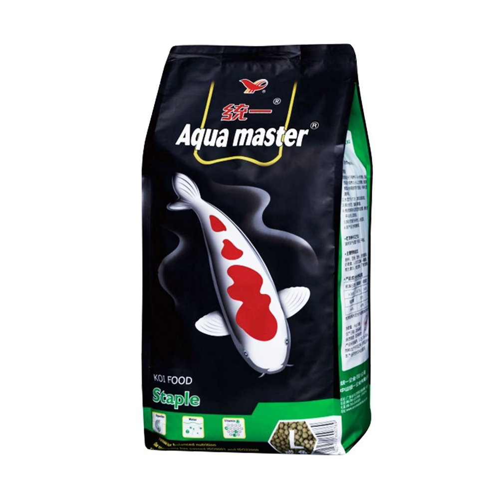 A bag of Aqua Master Koi Food Staple fish food, featuring a black and green packaging design with a red and white koi fish illustration on the front.