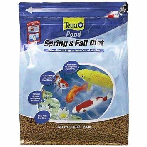 abe dumping box of fish food into koi pond TetraPond Spring & Fall Diet Fish Food