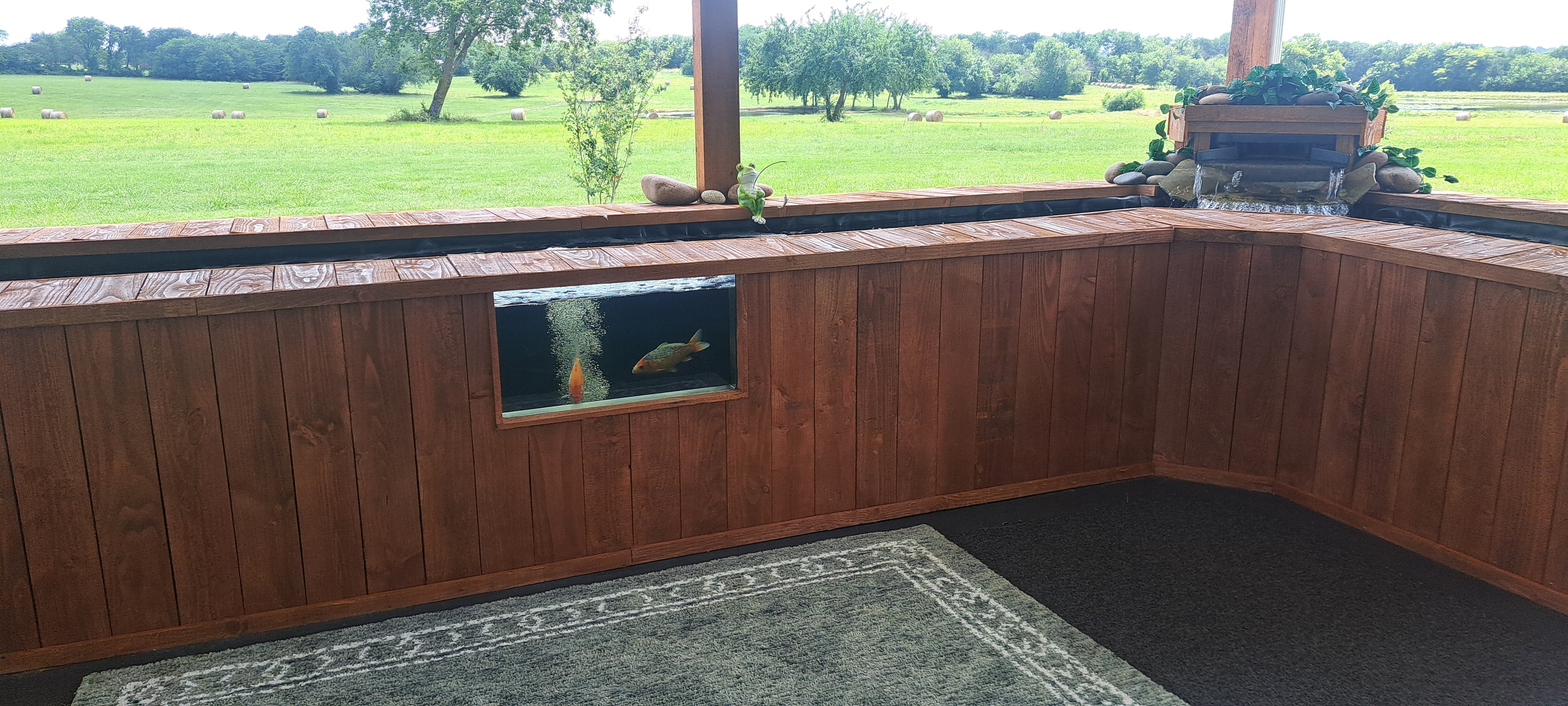 Customer photo: koi pond and viewing window in a garden setting