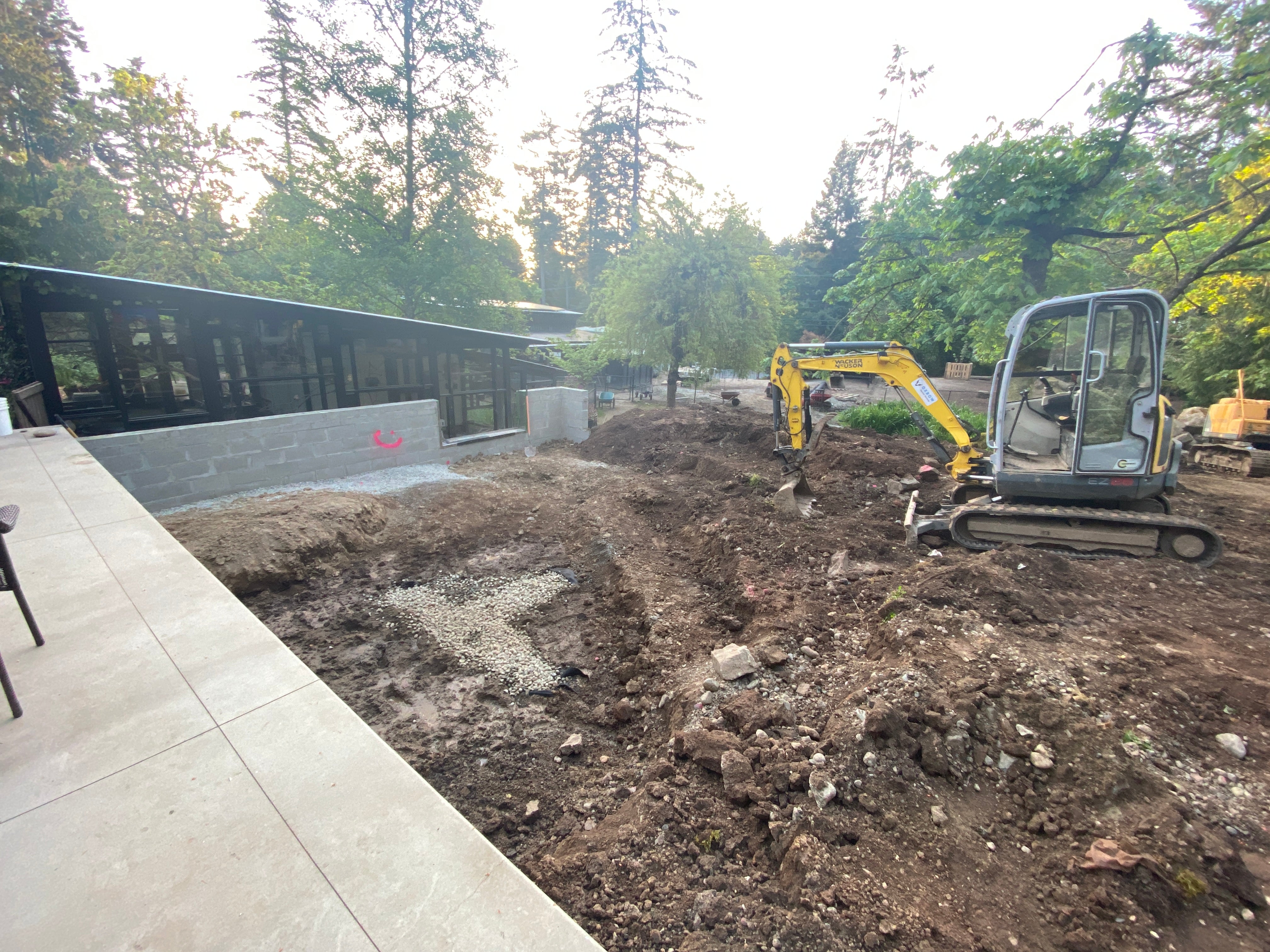 Customer photo: custom Pond Portals window set into a block pond wall during construction